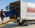 Removalists loading a truck for a furniture removal service