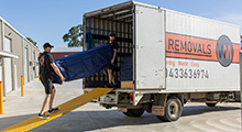 Removalists loading a truck for a furniture removal service