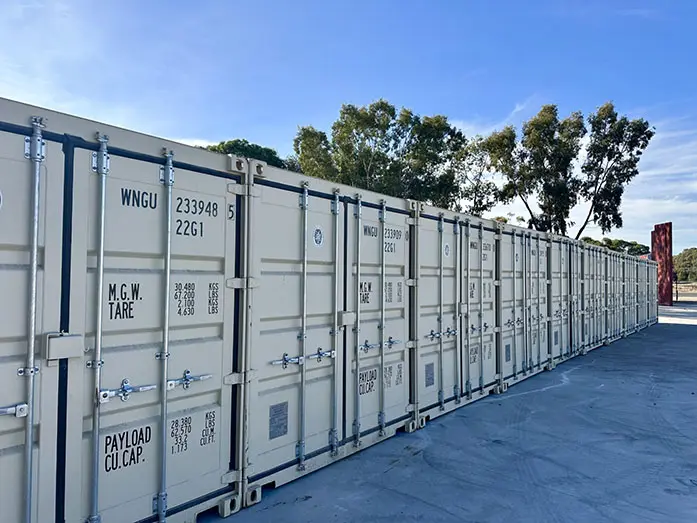 Row of secure steel storage containers at WM Removals facility in Adelaide, showcasing safe and reliable Storage Adelaide solutions
